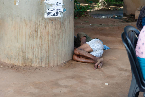 Salvador, Bahia, Brazil - August 11, 2023: Homeless man seen lying on the ground sleeping under an overpass in the city of Salvador, Bahia.