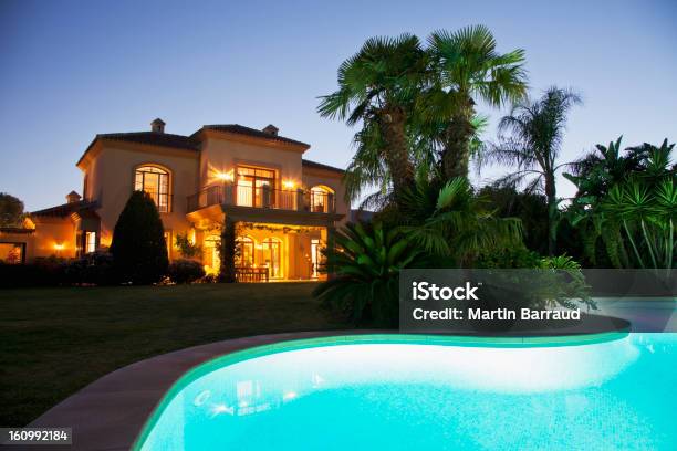 Luxury Swimming Pool And Villa Illuminated At Night Stock Photo - Download Image Now