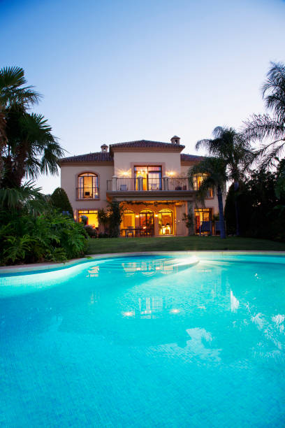 istock Luxury swimming pool and villa at dusk 160992240