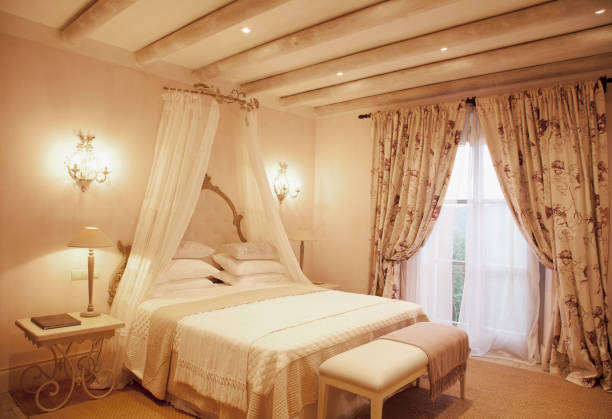 istock Sconces and canopy above bed in luxury bedroom 160992248
