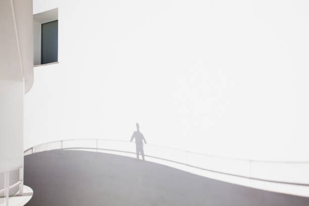 istock Shadow of businessman leaning on railing 160992407