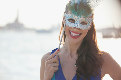 Carnival mask on a glitter golden background.