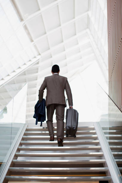 istock Businessman with suitcase ascending stairs 160992584