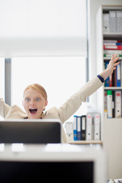 istock Exuberant businesswoman at computer in office 160992588