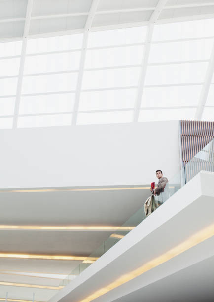 istock Businessman standing at glass balcony railing in modern building 160992608