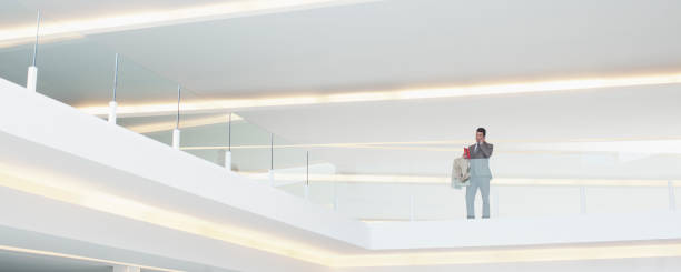 istock Businessman at glass balcony railing in modern office 160992614