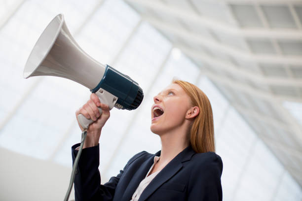 istock Businesswoman shouting into bullhorn 160992616