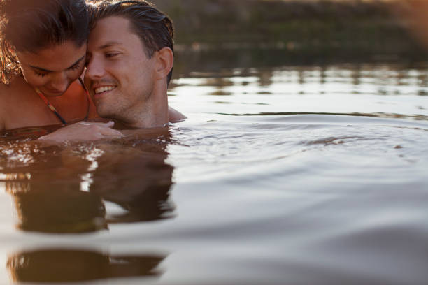 istock Smiling couple swimming in lake 160992682