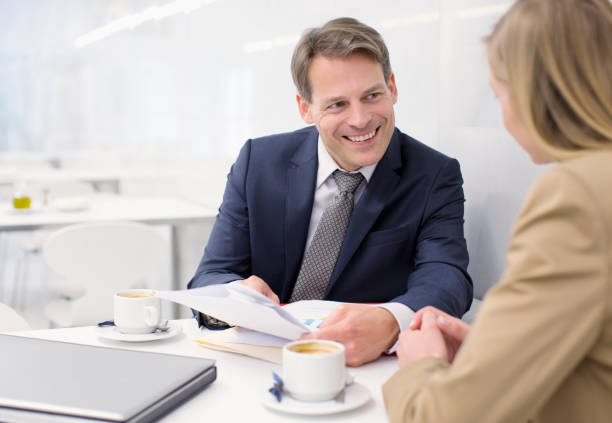 istock Smiling business people discussing paperwork in cafe 160992724