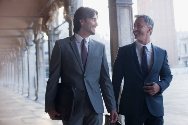 istock Smiling businessman walking along corridor 160992834