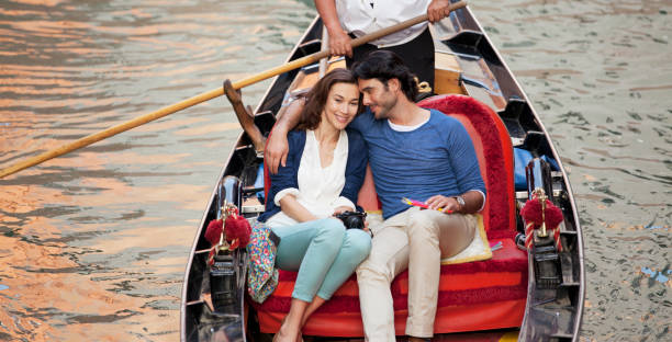 istock Smiling couple riding in gondola in Venice 160992966