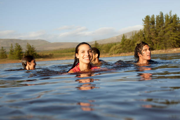 istock Smiling friends swimming in lake 160992999