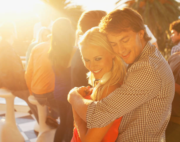 istock Smiling couple hugging on sunny balcony 160993179