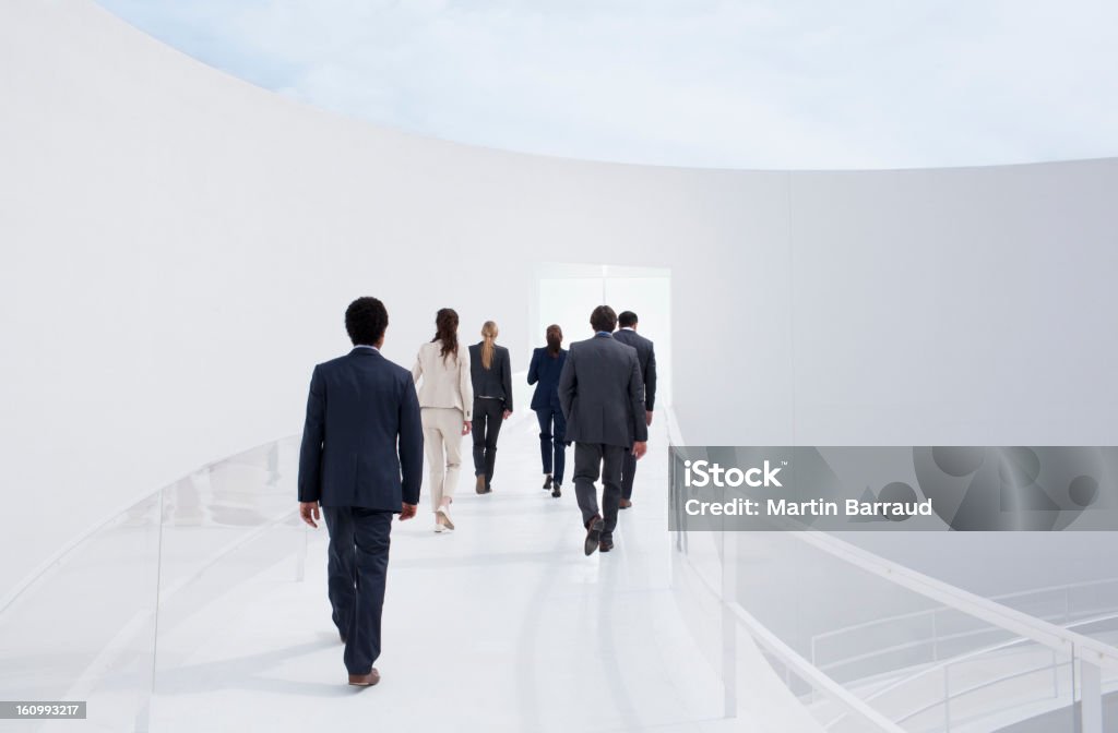 Business people walking toward doorway  Rear View Stock Photo
