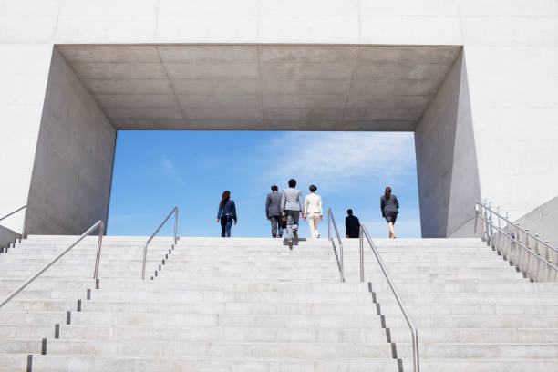 istock Business people ascending concrete steps toward blue sky 160993235