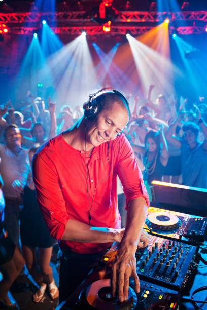 istock DJ at turntable with crowd on dance floor in background 160993266