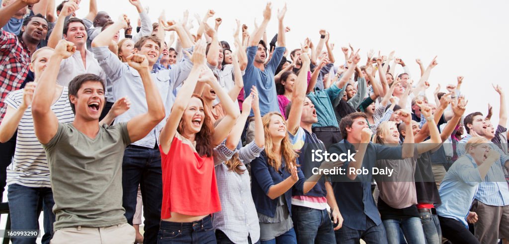 Cheering fans in crowd  Crowd of People Stock Photo