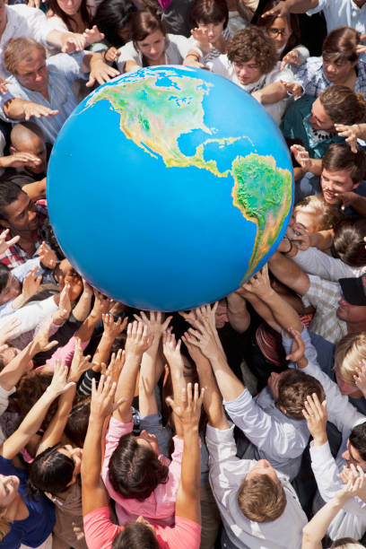 istock Crowd of people reaching for globe 160993335
