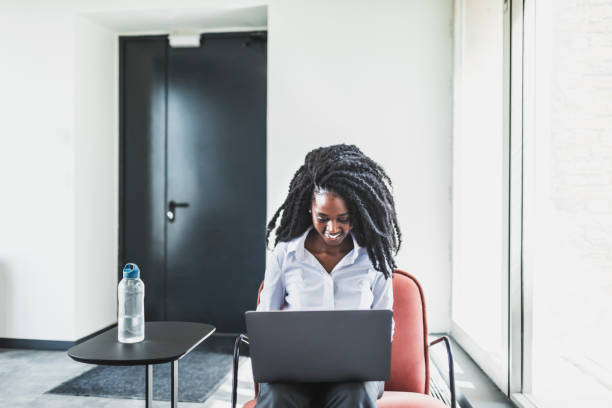 istock Black young businesswoman working from coworking using laptop 1609948130