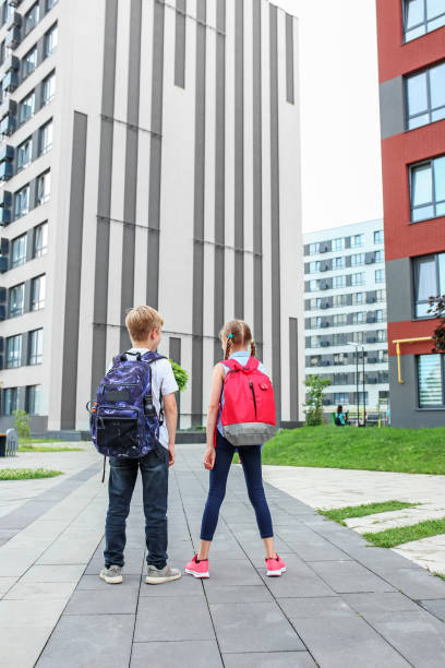 istock Back to school. Children go to school for study. Beginning of school lessons. Back view. Copy space 1609979232