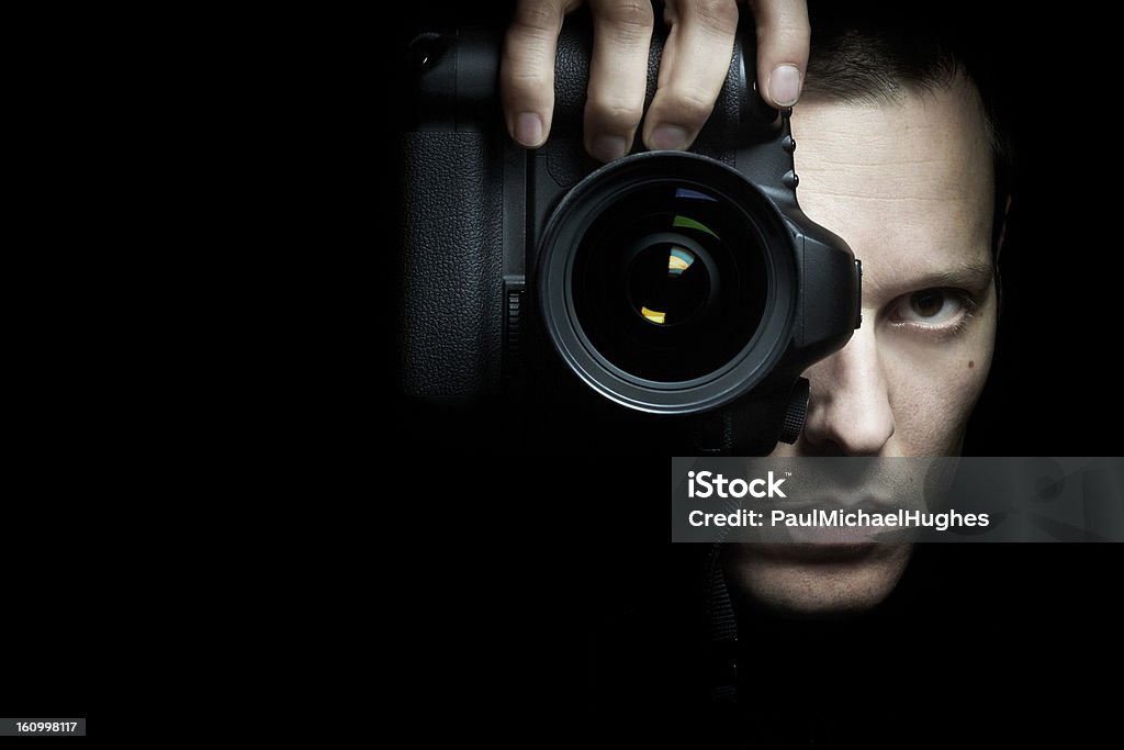Photographer taking photo with camera Photographer taking photo with camera on black background Black Background Stock Photo