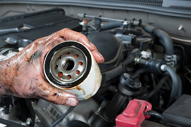 istock Auto mechanic holding oil filter 160999569
