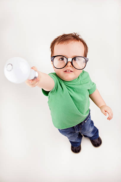 istock Young Happy Intelligent Boy Raising and Handing Over Lightbulb 160999678