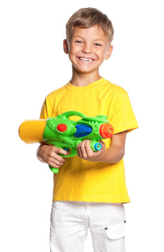 Happy boy with plastic water gun isolated on white background