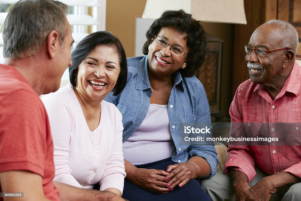 Group Of Senior Friends Chatting At Home Together Group Of Senior Friends Chatting At Home Together Smiling Senior Adult Stock Photo