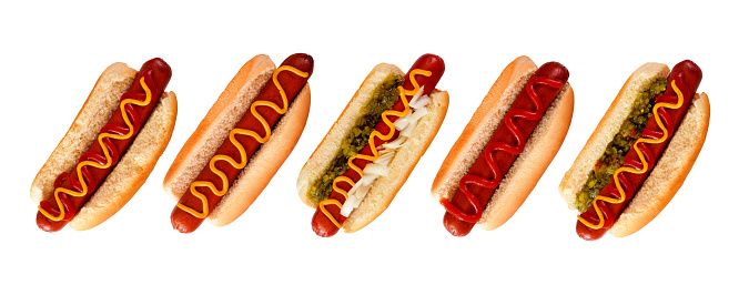 Group of unique hot dogs with an assortment of toppings. Top view isolated on a white background.