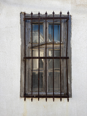 Old house window. Old iron fence.
