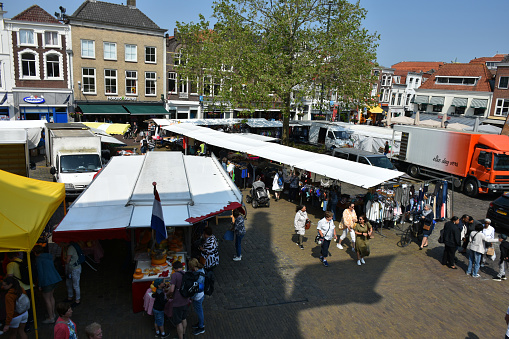 Gouda, The Netherlands - June 6, 2023: Scene Of Building Exterior, Street Vendors With Land Vehicle, People Walking, Sitting Down, Eating And Drinking, Shopping And More During Gouda Annual Traditional Merchant Cheese Market In South Holland The Netherlands Europe