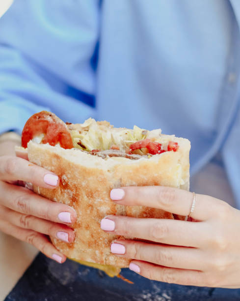 istock A young person enjoying a beef sandwich 1610121184
