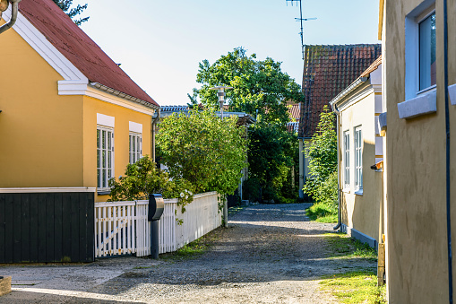 Skagen city street with traditional yellow houses and restaurants, cafes and boutiques on a summer sunny day. Skagen, Denmark - August 12, 2023.