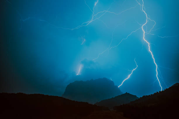 istock Bright lightning over Alps mountains at night 1610148466