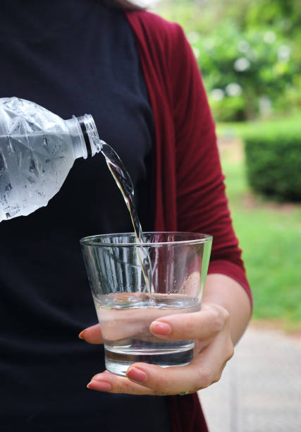 istock A woman pouring water into a drinking glass 1610153222