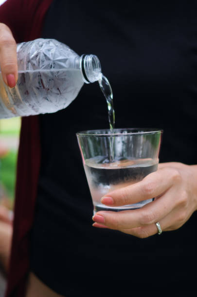 istock A woman pouring water into a drinking glass 1610153766