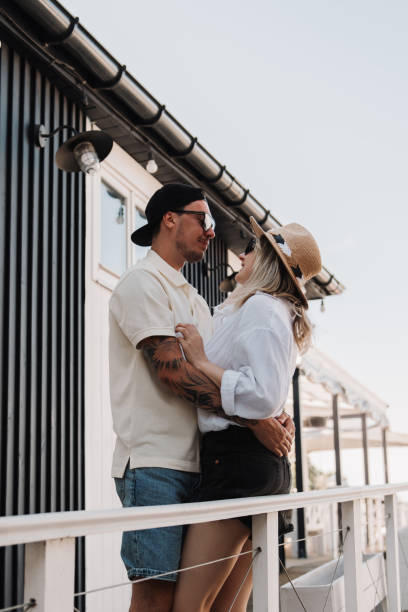 istock Young romantic couple embracing and smiling while spending summer day on the house terrace together 1610163315