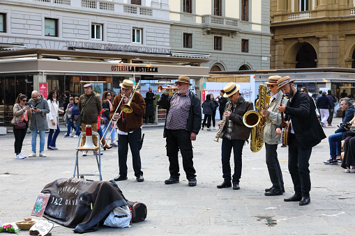 Florence, Italy - April 16, 2023: The Old Florence Jazz Band perform music in Piazza della Repubblica to entertain tourists and locals walking around this city square