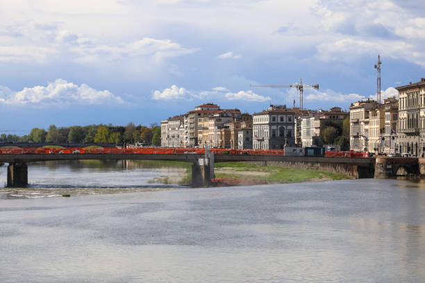 Florence, Italy - April 15, 2023: The Amerigo Vespucci Bridge spans the Arno River. The bridge is now under renovation