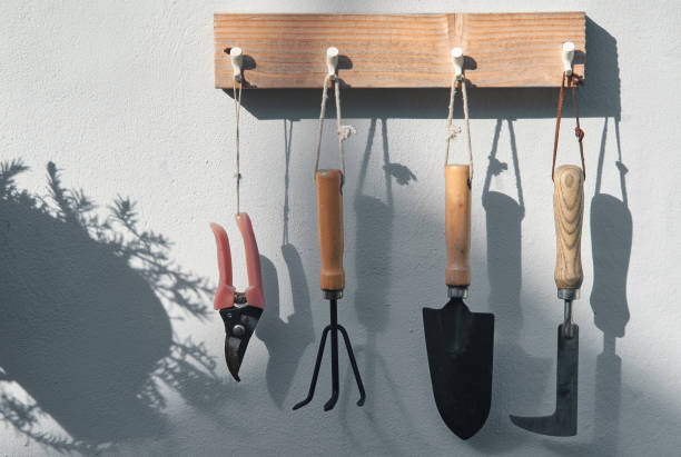 The gardening tools hanging on the wooden dock stock photo