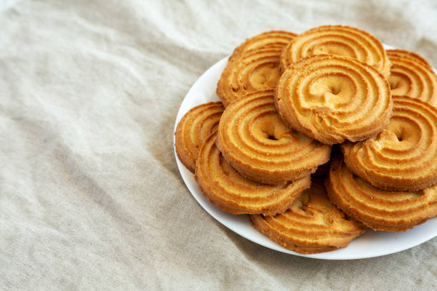 istock Homemade Sprits Biscuits on a Plate, side view. Space for text. 1610188323
