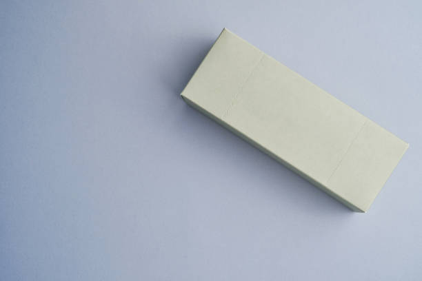 Colored small gift box on a white background. Postal services, delivery. Mock-up packaging. Gift box, gift. Box close-up. Empty packaging, empty space