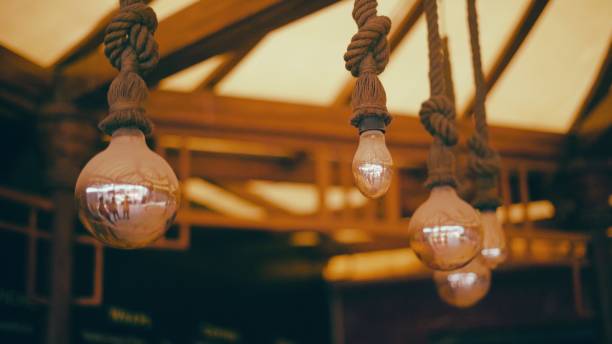 istock Vintage Bulbs hanging by ropes 1610210617