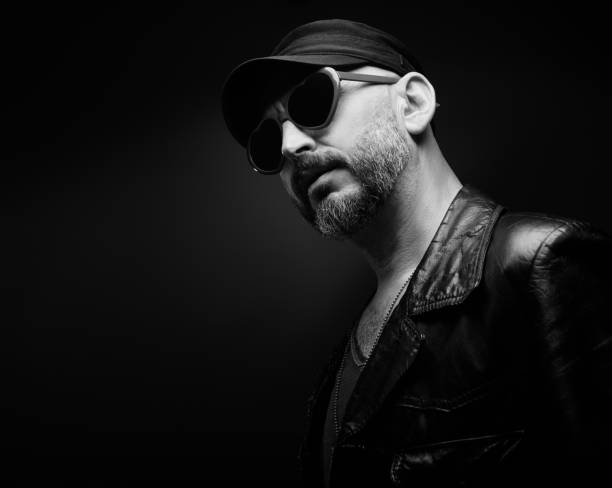 istock Stylish handsome man wearing leather jacket with heart shaped sunglasses 1610280664