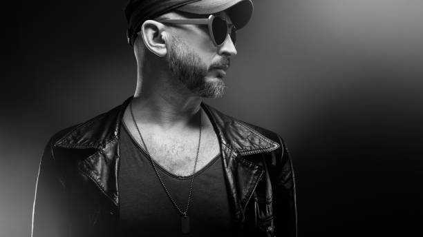 istock Stylish handsome man wearing leather jacket with heart shaped sunglasses 1610282247