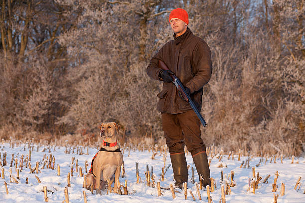 istock Young hunter with dog at winter hunting 161029631