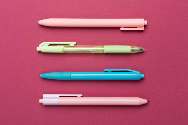 Pastel coloured pens on color backgroung, top view