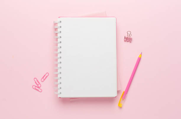 istock Notebooks with pen on color background, top view 1610297455