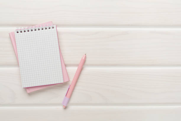 istock Notebooks with pen on wooden background, top view 1610297459